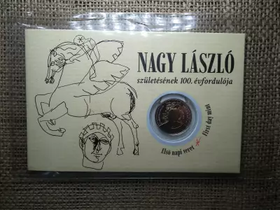 Nagy László 100 forint 2025 - Első napi veret díszcsomagolásban